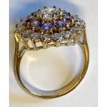 A 9CT YELLOW GOLD AMETHYST AND WHITE SAPPHIRE CLUSTER RING, on a basket setting, hallmarked,
