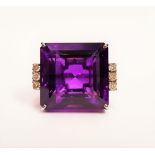 A WHITE GOLD & DIAMOND & AMETHYST RING, with very large central amethyst stone with 6 diamonds to