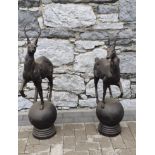 A PAIR OF METAL STAGS ON A BALL