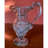 A FINE EARLY 19TH CENTURY IRISH CUT GLASS WATER JUG / EWER, circa 1800, the rim has a serrated