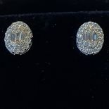 A PAIR OF 18CT WHITE GOLD HALO DIAMOND STUD EARRINGS, .60cts
