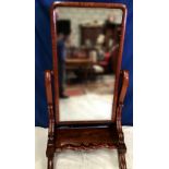 A VERY FINE VICTORIAN CHEVAL SWING / DRESSING MIRROR, with scroll shaped supports and raised on