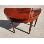 A VERY FINE GEORGE III DEMI-LUNE TEA TABLE, with wonderful flame mahogany and rosewood cross-banding