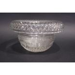 AN IRISH CUT GLASS CENTRE BOWL with diamond cut roll over rim, with angled step cut design to the