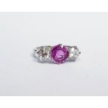 AN 18CT WHITE GOLD 3 STONE DIAMOND & SAPPHIRE RING, with a central pink sapphire flanked by a