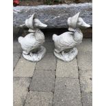 A PAIR OF STONE GARDEN ORNAMENTS in the form of ducks with bonnets