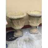 A PAIR OF STONE GARDEN URNS, with figurative decoration to the body, each 57cm high approx
