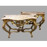 A VERY FINE & RARE PAIR OF MARBLE TOPPED CONSOLE TABLES, each with carved gilt frames, the four