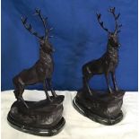 A PAIR OF BRONZE ORNAMENTAL STAGS, after Jules Moigniez, both stand on an incline on marble stone