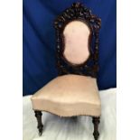 A VICTORIAN CARVED NURSING / SIDE CHAIR, with scrolling foliage detail to the decorative back having