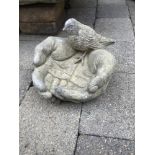 A STONE BIRD BATH IN THE FORM OF A HAND