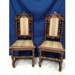 A PAIR OF CARVED OAK HALL / SIDE CHAIRS, each with carved fruit and foliage decoration to the