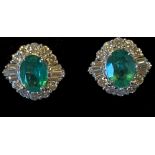 A PAIR OF 18CT WHITE GOLD COLOMBIAN EMERALD & DIAMOND CLUSTER EARRINGS, finished with round