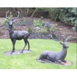 A PAIR OF LARGE DECORATIVE STAGS, one seated, one standing