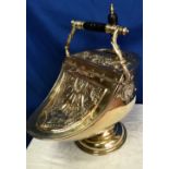 A VICTORIAN BRASS COAL SCUTTLE, helmet shaped, with decorative motif to the body and lid, includes