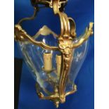 A BRASS HANGING LIGHT / LANTERN, the body curved tapered glass, having foliage motif, 2 lamp