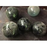 A COLLECTION OF 5 GLASS FISHING FLOATS, some possibly Japanese, one with a German glass makers mark,