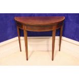 A 19TH CENTURY MAHOGANY DEMI LUNE FOLD OVER CARD TABLE, with crossbanded rim, and string in laid