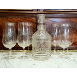 A GLASS DECANTER WITH GLASSES, 7 glasses having horse decoration