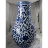 A CHINESE BLUE AND WHITE VASE, with heaping and piling flowers, and scrolling leaf pattern, 33cm