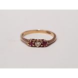 A 9CT GOLD THREE STONE RING ,with a central diamond flanked by ruby stones, marked 375