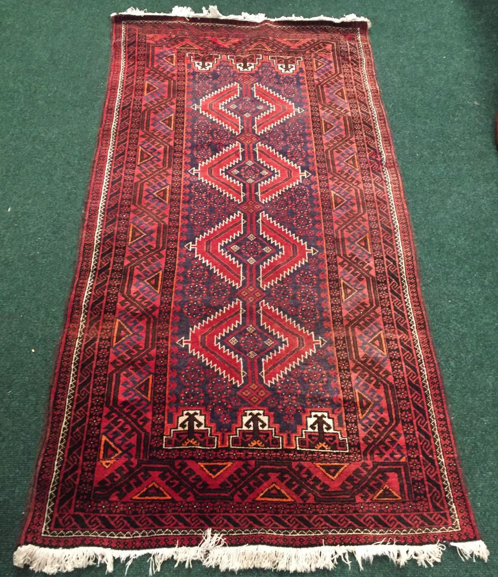 A PERSIAN BALOUCH RUNNER, with multiple border and central four medallions of geometric design,