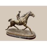 AN EARLY 20TH CENTURY BRONZE SCULPTURE, of a horse and jockey, 26" wide x 20" tall x 11" deep