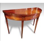 A GEORGE III MAHOGANY DEMI-LUNE FOLD OVER TEA TABLE, with ebony banded top, single frieze drawer and