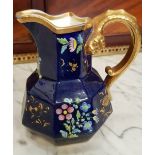 A 19TH CENTURY SPODE CREAM JUG with dark blue glazed body decorated with floral motif and gilt rim