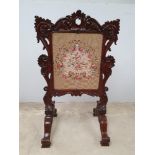 A GOOD QUALITY 19TH CENTURY ROSEWOOD FIRE SCREEN, highly carved with scroll and foliage motif,