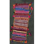 A COLOURFUL "SADDLE BAG" hand woven from Northern Afghanistan, traditionally used to carry