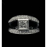 AN 18CT WHITE GOLD PRINCESS CUT DIAMOND SOLITAIRE RING, in a split shank design of two diamond bands