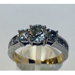 AN 18CT WHITE & YELLOW GOLD THREE STONE DIAMOND RING, with diamond shoulders , centre diamond 1.35