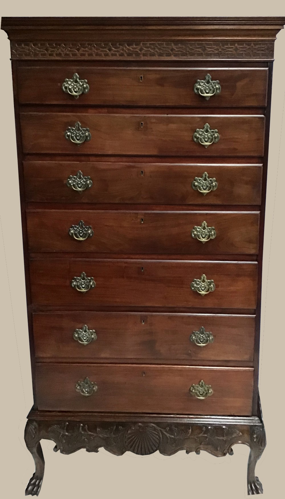 A VERY FINE IRISH STYLE REGENCY TALL BOY CHEST, with blind fret work decoration to the top, and 7