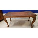 A LOW RISE COFFEE TABLE, with carved decorative top, having floral motif, raised on cabriole