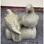 A GARDEN ORNAMENT IN THE FORM OF TWO WOOD PIGEONS SEATED ON A LOG