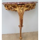 A NEATLY SIZED 19TH CENTURY MARBLE TOPPED GILT CONSOLE TABLE, single leg, with carved foliage