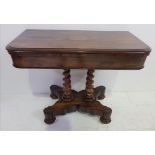 A GOOD QUALITY 19TH CENTURY ROSEWOOD FOLD OVER CARD TABLE, raised on twin barley twist pillars