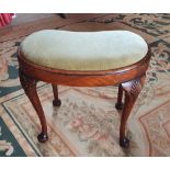 A WALNUT KIDNEY SHAPED STOOL, with shell motif to the knee and pad feet, 14” deep, 21.5” wide x 17.