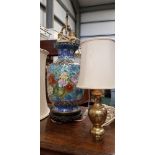 A LARGE CLOISONNE TABLE LAMP, with floral and butterfly motif, sitting on a carved base, with double