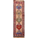 A VERY FINE PERSIAN FLOOR RUNNER, hand knotted, with large diamond shaped geometric motif in the