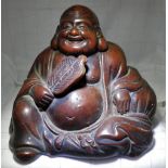 AN ANTIQUE TERRACOTTA LAUGHING BUDDHA, signed, 20cm wide x 18cm high approx