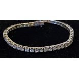 AN 18CT WHITE GOLD DIAMOND TENNIS BRACELET, 8.44cts of matching round brilliant cut diamonds of very