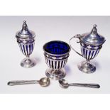 A CASED SILVER CONDIMENT SET, includes; three silver containers with blue glass inserts, and two