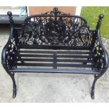 A PAIR OF BLACK CAST IRON GARDEN BENCHES, with floral and foliage intertwined back rests with