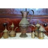 A COLLECTION OF 'DALLAH' POTS, of various sizes, each with a hinged lid and curved spout, along with