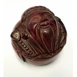 A CARVED WOODEN BOX, in the form of a bearded man, 2" tall