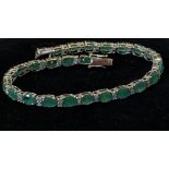 AN 18CT WHITE GOLD EMERALD & DIAMOND TENNIS BRACELET, 17cts of natural Emeralds with one carat of