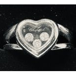 AN 18CT WHITE GOLD ORIGINAL SIGNED "CHOPARD" HAPPY DIAMOND RING, with three moving diamonds in a