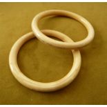 A PAIR OF CHINESE IVORY BANGLES, circa 1890 – 1920 one with inset gold bead detailing, both heavy